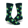 A pair of dark green crew socks with a repeating pattern of green frogs sitting on lily pads and catching flies with their tongues.