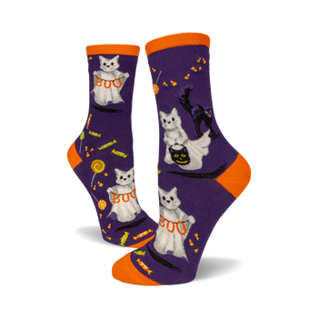 front view of a pair of purple socks with white cats dressed as ghosts trick-or-treating.