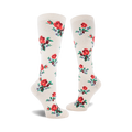 Pair of cream-colored knee-high socks adorned with a repeating pattern of red roses and small blue flowers.