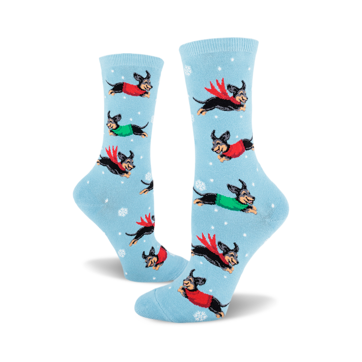 Crew socks in light blue with a repeating pattern of dachshunds wearing red and green sweaters, flying through a snowy scene.