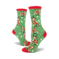 A pair of women's crew socks in green with a red cuff. The socks feature a pattern of cute reindeer and snowflakes.