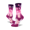 Women's crew socks in pink and purple ombre. Design features snowflakes and stylized winter trees.
