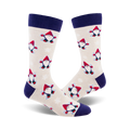 Cream crew socks with navy blue cuffs, adorned with a repeating pattern of red-hatted snow gnomes playfully throwing snow.