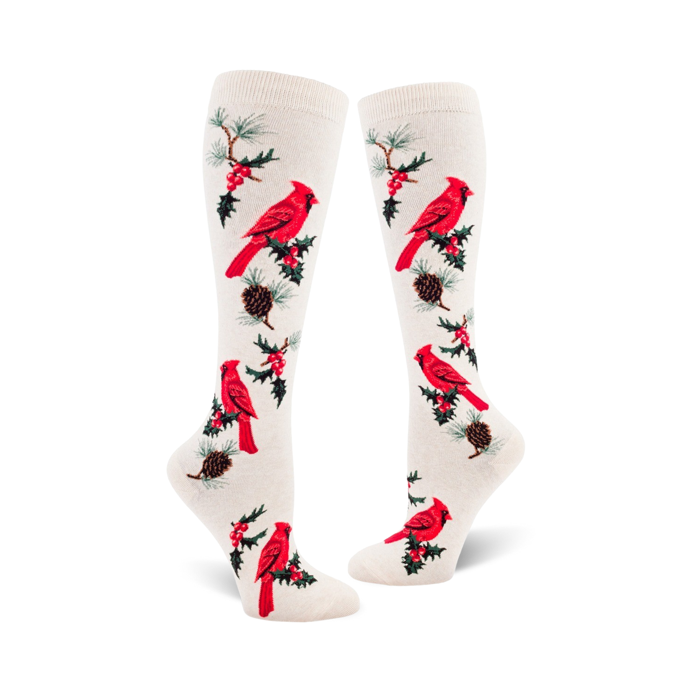 Pair of cream-colored knee-high socks with a repeating pattern of red cardinals, holly berries, and pine cones.