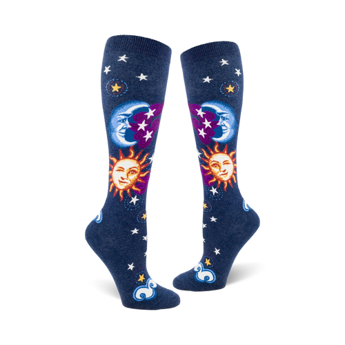 Pair of navy blue knee-high socks with whimsical sun, moon, and stars design.  Features smiling sun and moon faces, purple accents, and white stars.