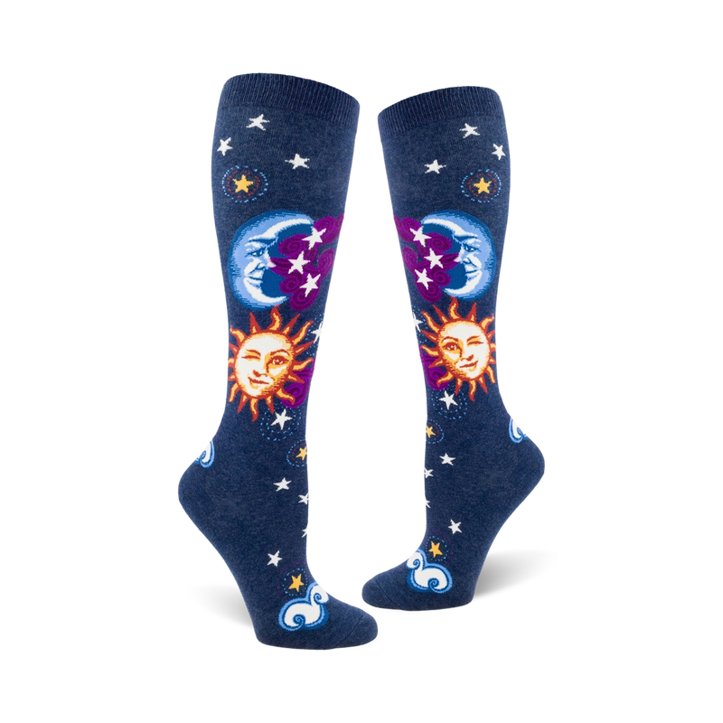 Pair of navy blue knee-high socks with whimsical sun, moon, and stars design.  Features smiling sun and moon faces, purple accents, and white stars.