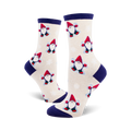 Cream crew socks with a repeating pattern of red-hatted snow gnomes making snow angels.  Navy blue cuffs.
