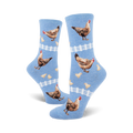 A pair of light blue crew socks with hens, chicks, and white picket fences. The chickens are brown and tan.