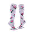 Pair of lavender knee-high socks adorned with a pattern of pink roses, green leaves, and tiny white flowers.