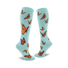 socks that are light blue with an all-over pattern of monarch butterflies. the butterflies are dark orange with black and white markings.