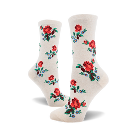 socks with a pattern of red roses with green stems and blue and white flowers with green stems. the background of the socks is off-white.