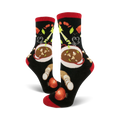 A pair of black crew socks with a red cuff, featuring a whimsical illustration of a bowl of soup and vegetables.