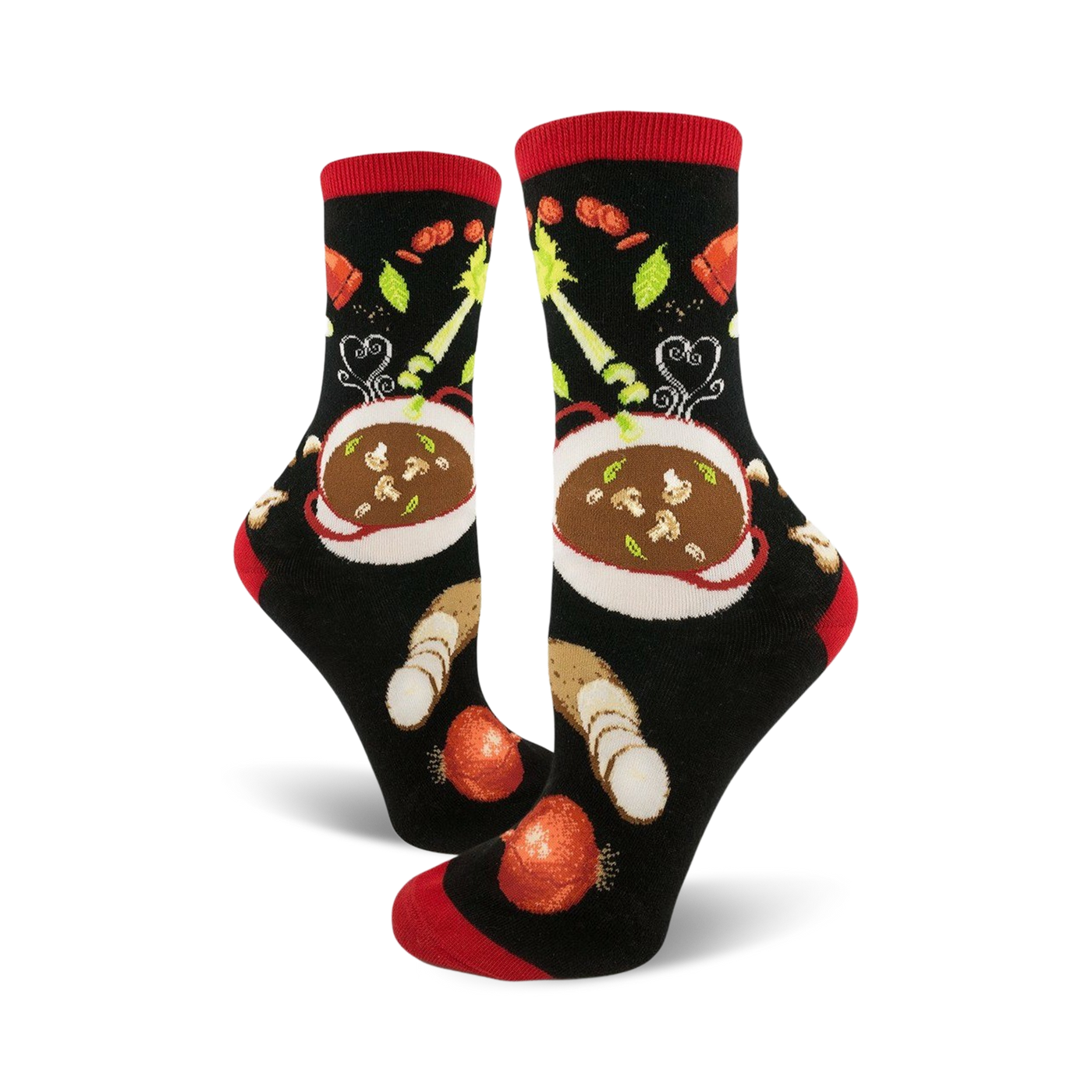 A pair of black crew socks with a red cuff, featuring a whimsical illustration of a bowl of soup and vegetables.