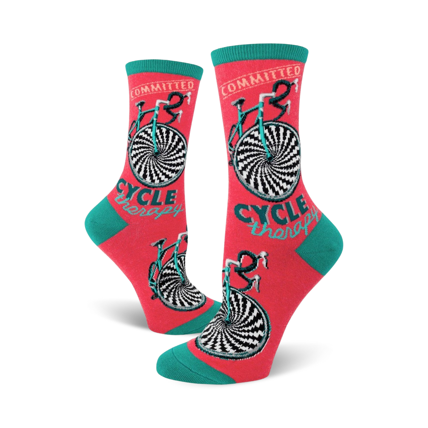 Crew socks in coral with teal cuffs. The design features a black and white hypnotic bicycle wheel and the words 'Cycle Therapy'.