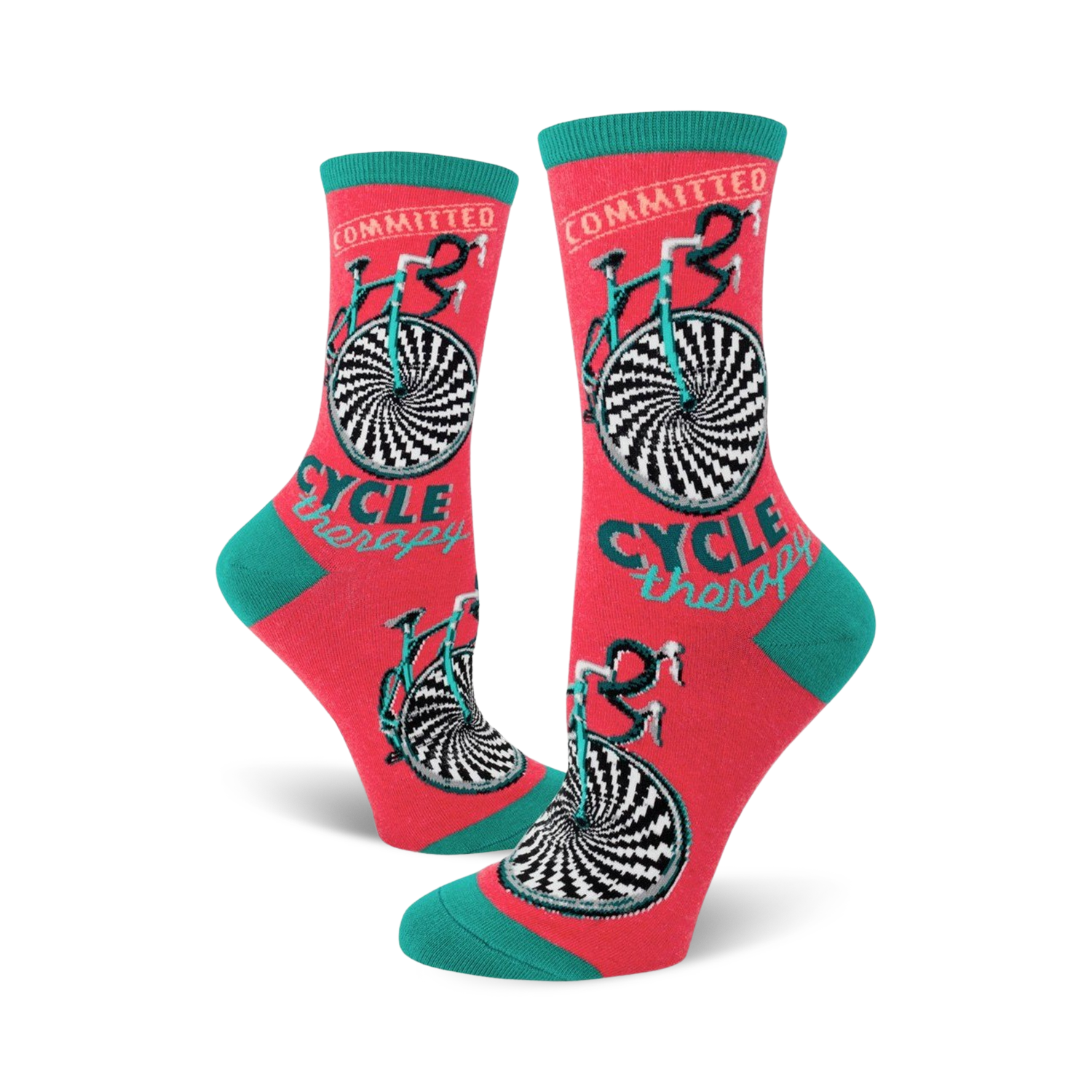 Crew socks in coral with teal cuffs. The design features a black and white hypnotic bicycle wheel and the words 'Cycle Therapy'.