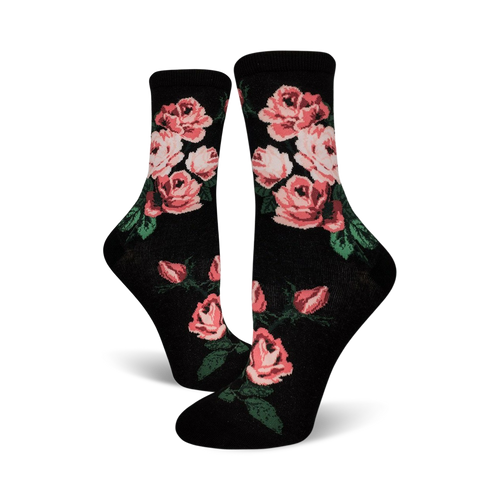 Pair of black crew socks with a pink rose pattern.  The roses are a blush pink with green leaves against a black background.