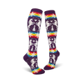 Pair of purple knee-high socks with a whimsical design featuring white unicorns, snowflakes, rainbow stripes, and small pine trees.