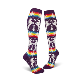 purple knee high socks featuring white unicorns, hearts, snowflakes, and rainbow designs.   