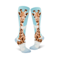 Pair of women's knee-high socks. Light blue background with a whimsical giraffe design in shades of brown and tan.