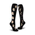 Pair of black knee-high socks showcasing the eight phases of the moon in beige/off-white. 