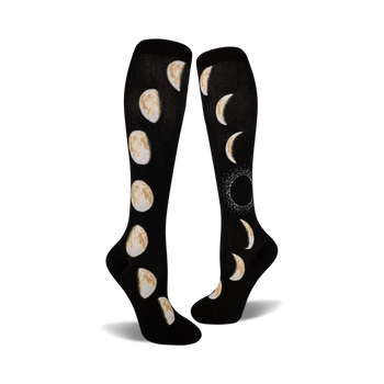 black knee-high socks feature a cream-colored pattern of moon phases, from new to full.  