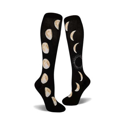 black knee-high socks feature a cream-colored pattern of moon phases, from new to full.  