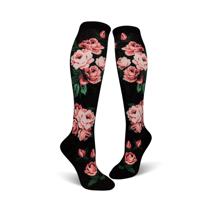 black knee-high socks with repeating pink rose and green leaf design.  