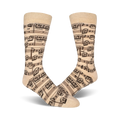 Close-up lifestyle shot of beige musical note socks on a person's feet.