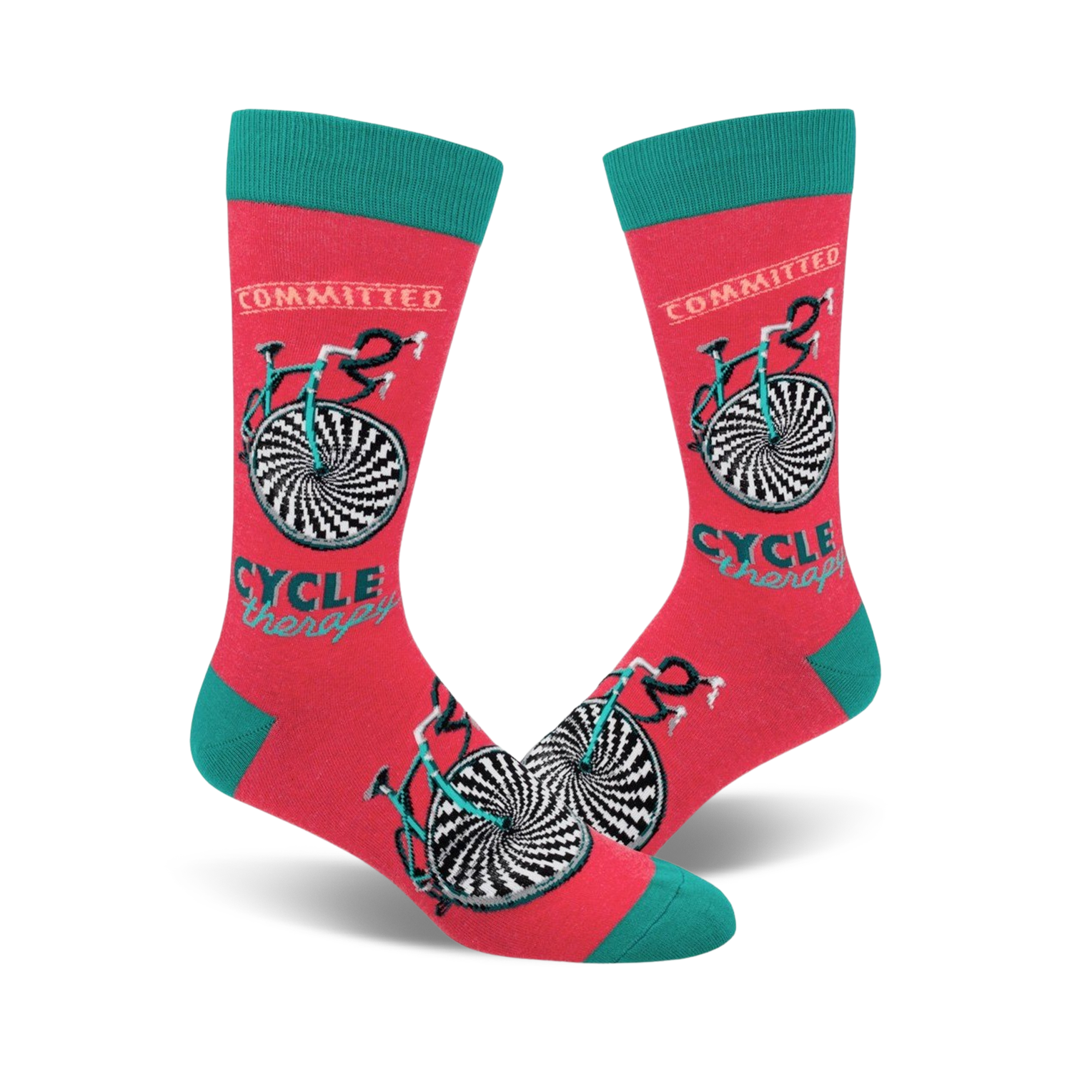 A pair of coral crew socks with a teal cuff. The socks feature a black and white hypnotic bicycle design and the words 'Cycle Therapy' and 'Committed'.