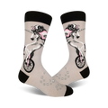 A pair of crew socks in grey with a whimsical design of a unicorn riding a unicycle, accented with pink and black details.