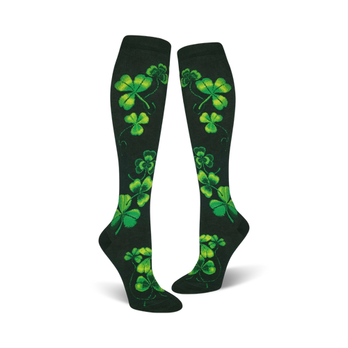 Pair of women's knee-high socks. Dark green background with bright green shamrock pattern. Festive and fun.