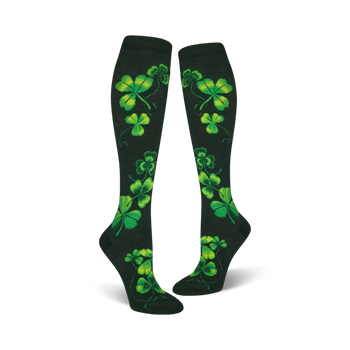 women's knee high shamrock socks featuring a bright green four-leaf clover design on a dark green background. perfect for st. patrick's day.  