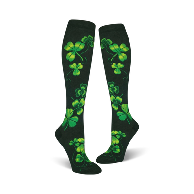 women's knee high shamrock socks featuring a bright green four-leaf clover design on a dark green background. perfect for st. patrick's day.  