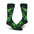 Pair of dark-green crew socks adorned with bright-green shamrock designs. The shamrocks are arranged in a playful, cascading pattern.