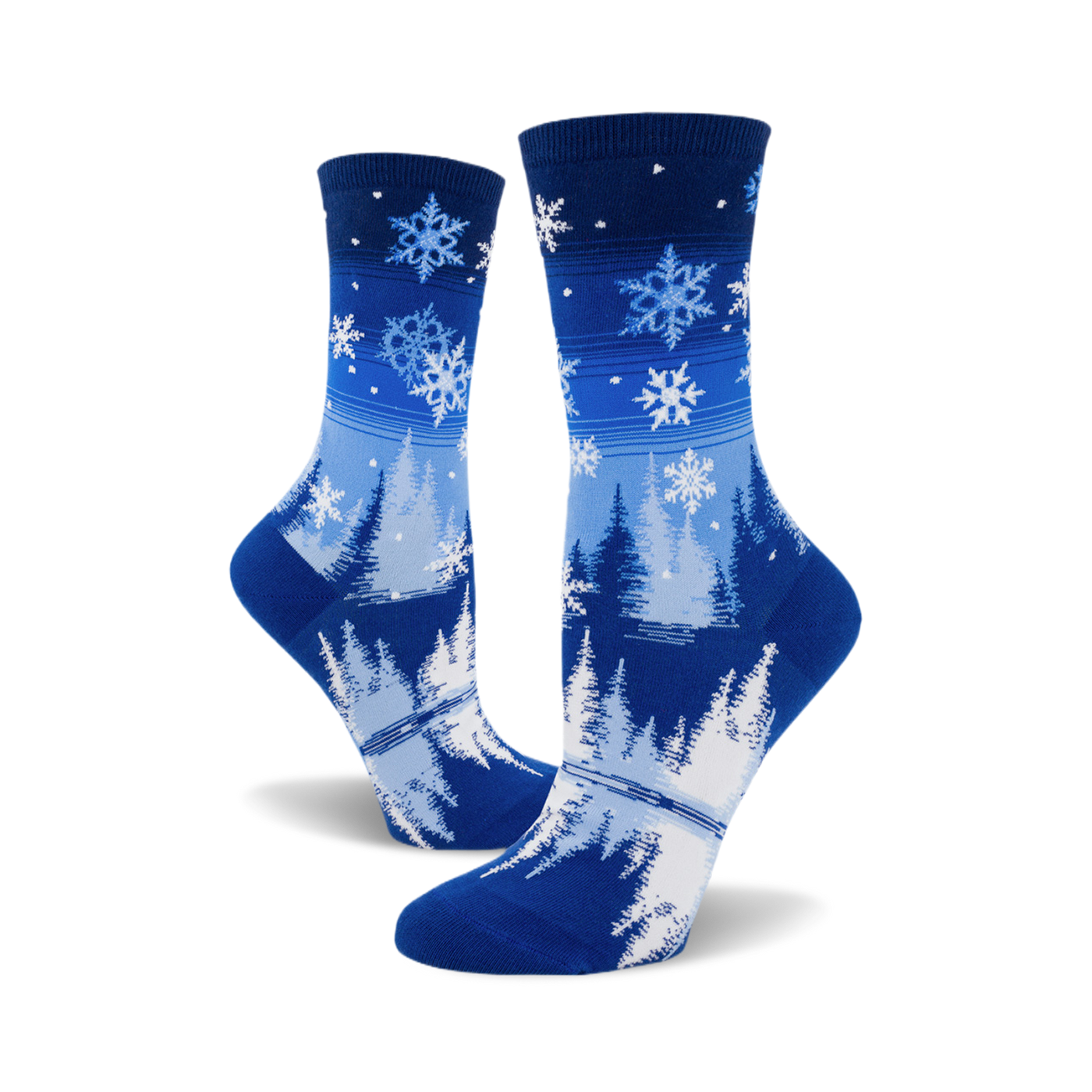 Pair of blue crew socks with a snowflake and pine tree design.  The socks are predominantly blue with white snowflakes and stylized trees.