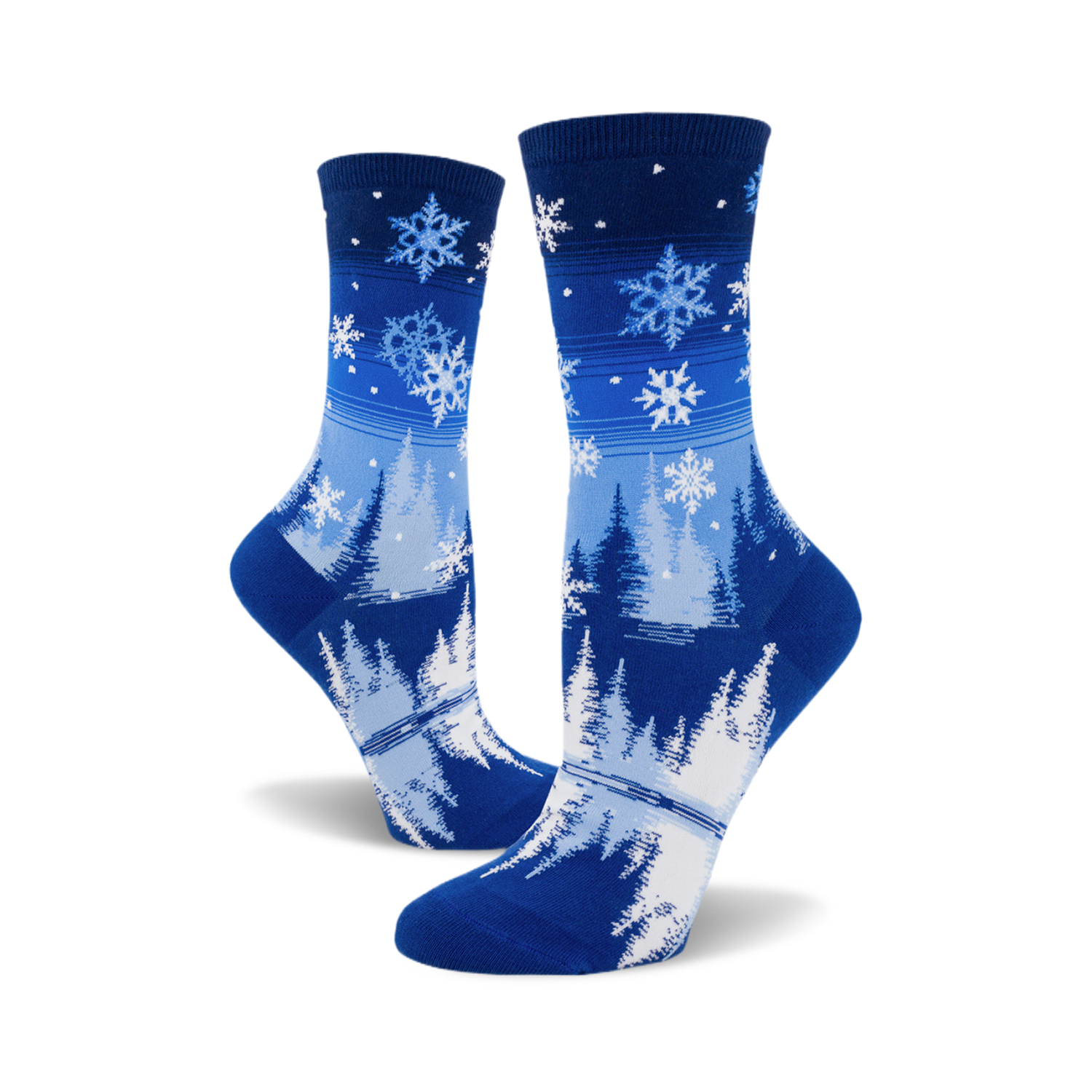 Pair of blue crew socks with a snowflake and pine tree design.  The socks are predominantly blue with white snowflakes and stylized trees.