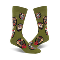 Olive green crew socks with a repeating pattern of dogs in top hats and bow ties. Each dog portrait is encircled.
