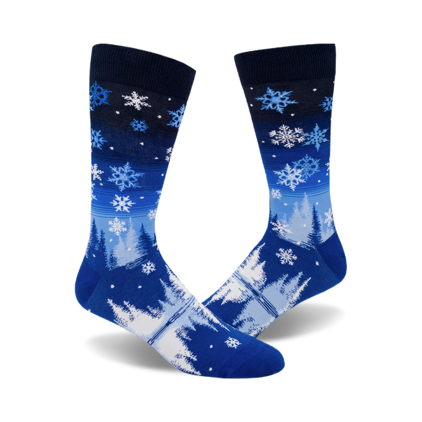 A pair of blue crew socks with a wintery design.  The socks feature white snowflakes and stylized trees on a blue and navy gradient background.