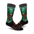 Crew socks in black, green, and brown featuring Bigfoot being beamed up by a UFO.  Footprints are printed on the lower part of the sock.