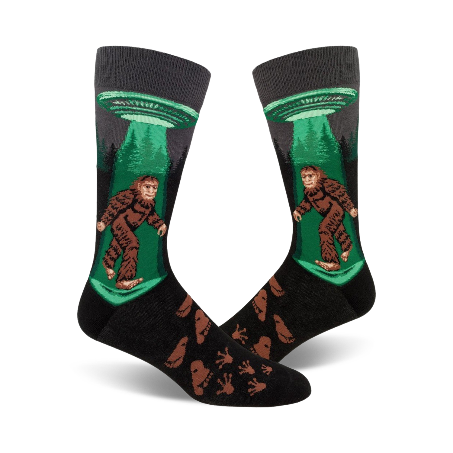 Crew socks in black, green, and brown featuring Bigfoot being beamed up by a UFO.  Footprints are printed on the lower part of the sock.