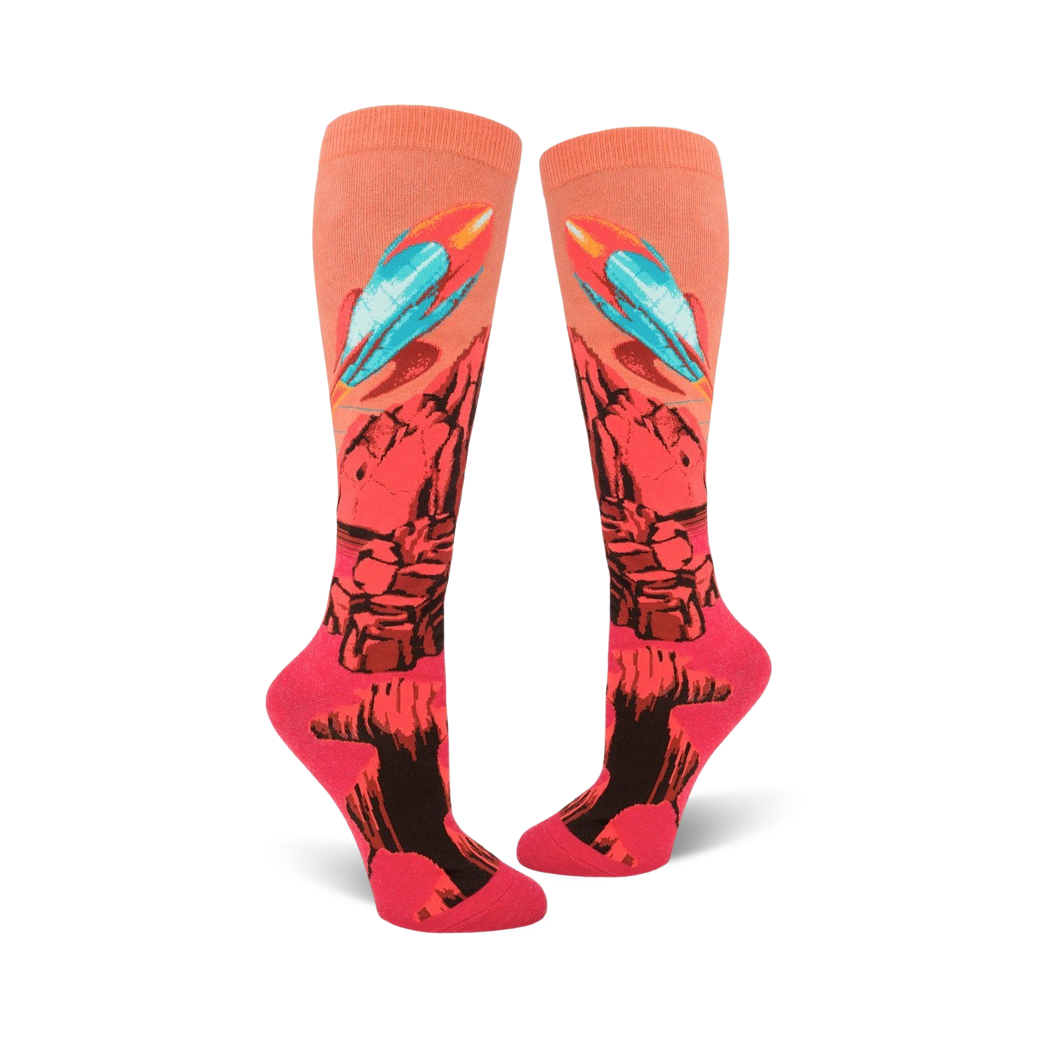 Pair of coral knee-high socks with a rocket launching from a rocky planet design. Features teal, orange, and black details.