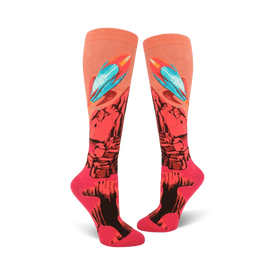 bright pink knee high women's socks feature a pattern of rockets blasting off from a red planet with blue flames. 