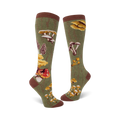 Close-up view of a pair of knee-high socks in olive green, showcasing the detailed mushroom illustrations and wood-grain background.