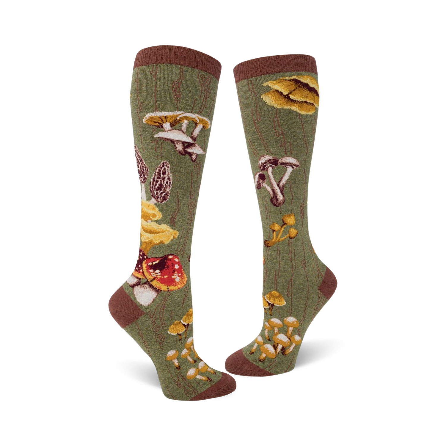 Close-up view of a pair of knee-high socks in olive green, showcasing the detailed mushroom illustrations and wood-grain background.