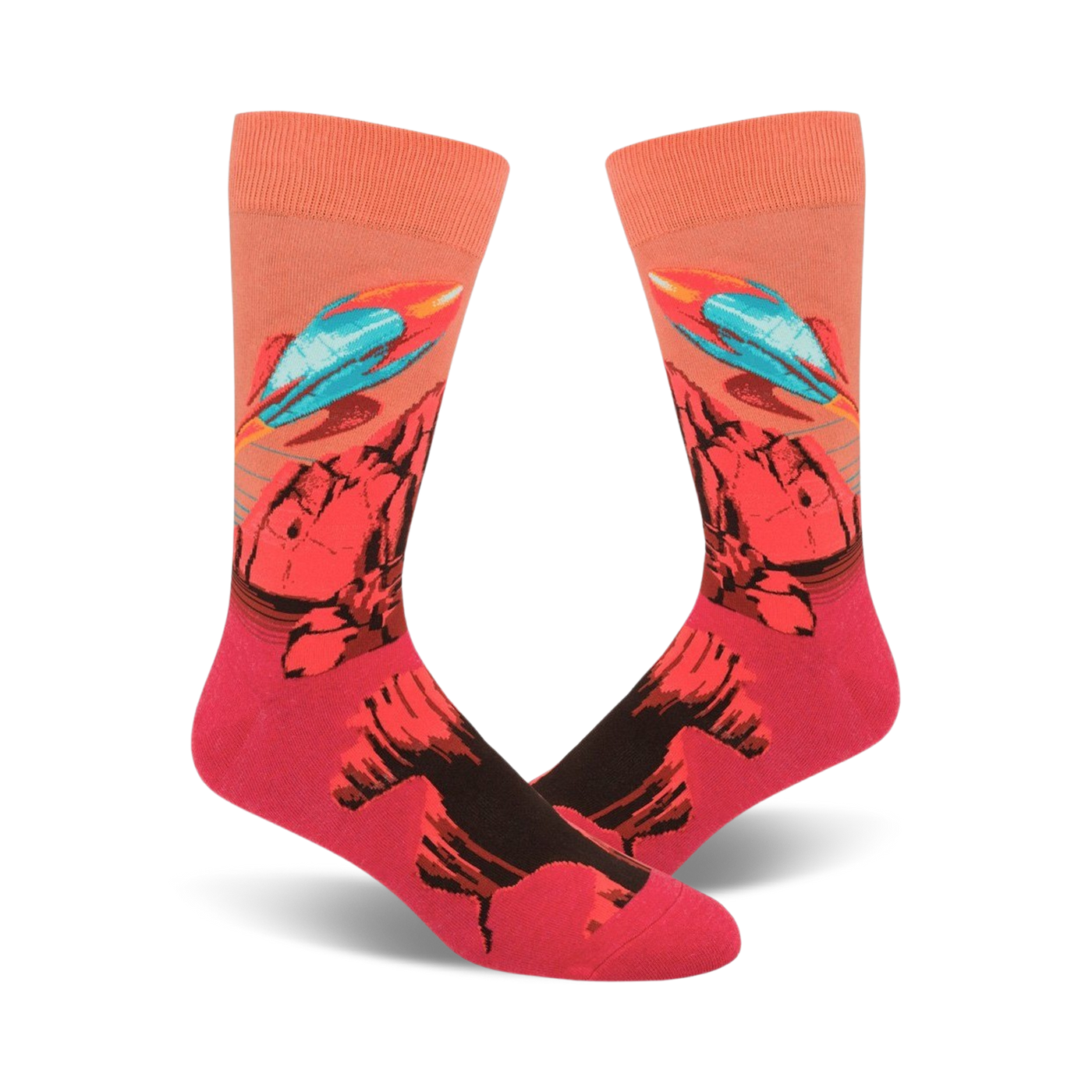 A pair of crew socks with a vibrant design featuring teal rockets launching from a red and black rocky landscape against a peach background.