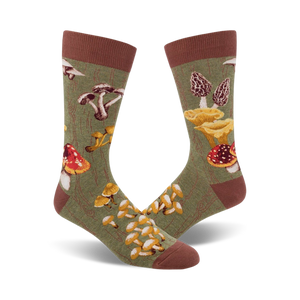 mens olive green crew socks with an allover pattern of mushrooms in red, yellow, orange, and brown. ribbed brown cuff.   