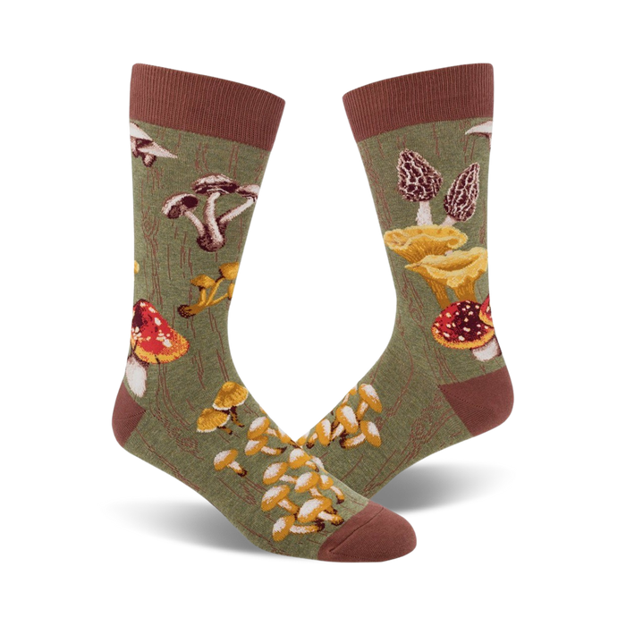 mens olive green crew socks with an allover pattern of mushrooms in red, yellow, orange, and brown. ribbed brown cuff.   