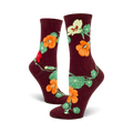 Lifestyle shot of a person wearing the burgundy nasturtium crew socks.
