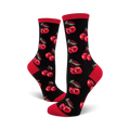 Pair of women's crew socks. Black background with repeating red cherry pattern. Red accents at the cuffs.