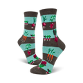 A pair of women's crew socks with teal and gray stripes and illustrations of carrots, radishes, and beets.